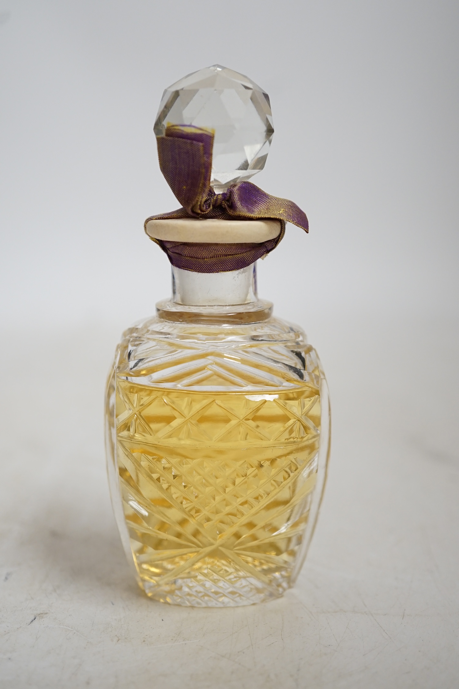 An early 20th century Vinolia cut glass scent bottle and stopper labelled White Lilac, with original case. Condition - fair